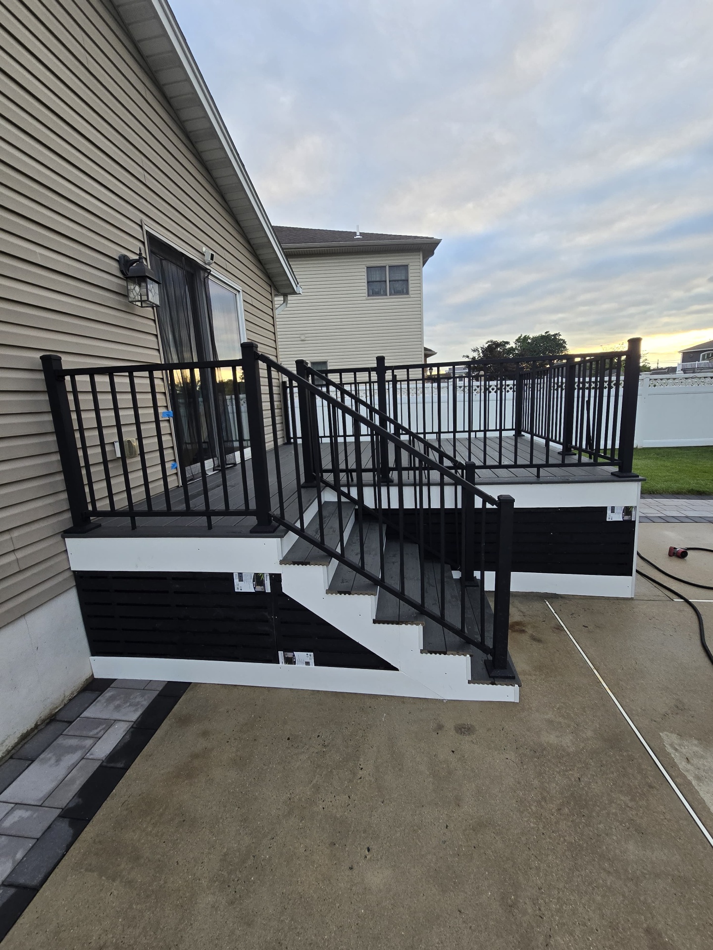 Finished composite deck with black aluminum railings and stairs